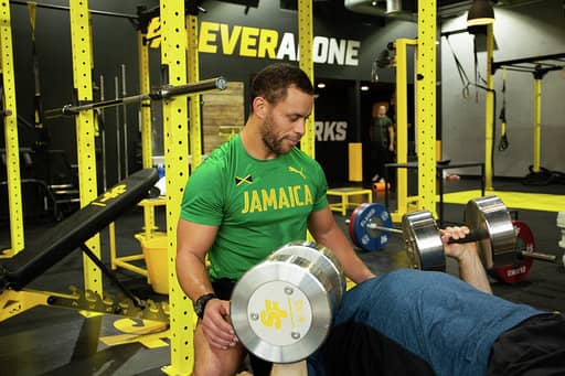 Lucas spotting a dumb bell bench press